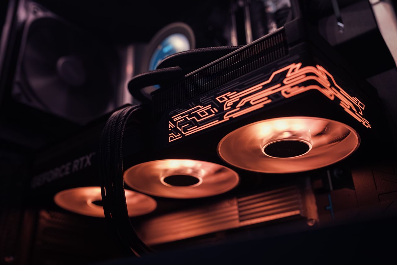 services-img Close-up of a gaming graphics card with illuminated RGB fans, perfect for high-end gaming setups.